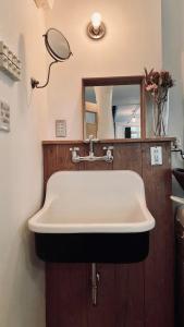 a white sink in a bathroom with a mirror at Good Space Hotel Yoyogi in Tokyo