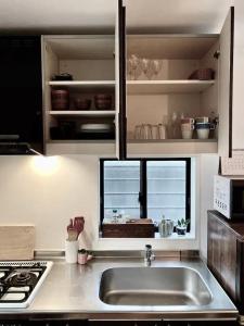 a kitchen with a sink and a window at Good Space Hotel Yoyogi in Tokyo