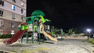 a playground at night with a slide at 1 bedroom condominium in Lapu2x in Lapu Lapu City