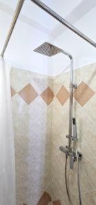 La salle de bains est pourvue d'une douche avec rideau de douche. dans l'établissement Joen Guesthouse, à Saranda