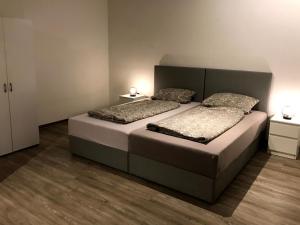 a bedroom with two beds and two night stands at 3 Zimmer Standard Apartment - 7 Betten - 2 x Badezimmer in Wolfsburg