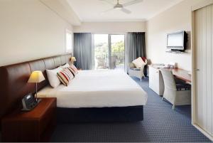 a hotel room with a bed and a desk at Caves House Hotel Apartments in Yallingup