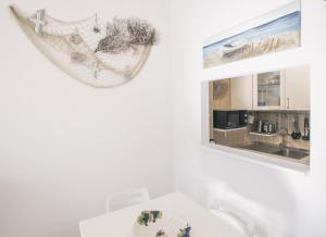 a white bathroom with a sink and a mirror at A casa di Alberta in Deiva Marina