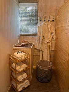 a walk in closet with a sink and towels at The Dome - Misty Mountain Reserve in Thornham