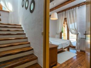 a stairway leading to a bedroom with a bed at Villa Wish Comfortable holiday residence in Čabrunići