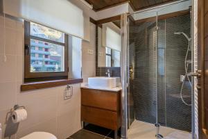 a bathroom with a sink and a shower at Luderna - Apartamento Val de Ruda A14 Montoliu in Baqueira-Beret