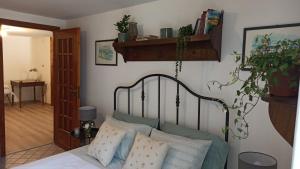 a bedroom with a bed with pillows and a plant at Pia's Home in pieno centro storico in Palermo