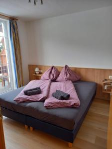 a bedroom with a bed with two pillows on it at Haus Aineckblick, Liftstrasse 250, Top 3 in Sankt Margarethen im Lungau