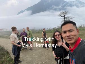 a group of people standing on a dirt road at My's Homestay sapa in Sa Pa