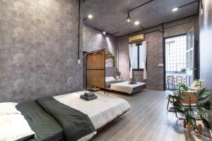 a bedroom with two beds in a room at 2 Bedroom Industrial Apartment in Central Saigon in Ho Chi Minh City