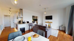 a living room with a dining table and a kitchen at Studio Apartment with 65" Smart TV in Newport