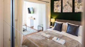 a bedroom with a bed with two towels on it at Studio Apartment with 65" Smart TV in Newport