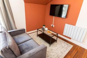 a living room with a couch and a table at Stylish Loft Apartment with View in Newport