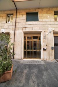 a building with a large door with a plant in front at Emily a Roma in Rome