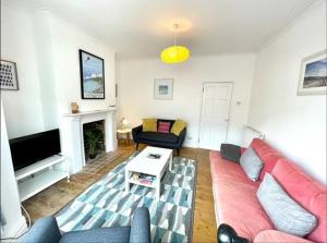 a living room with a couch and a fireplace at *Family Home in Mumbles. Close to the Beach* in The Mumbles