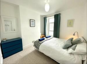 um quarto com uma cama grande e uma janela em *Family Home in Mumbles. Close to the Beach* em The Mumbles
