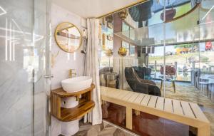 a bathroom with a sink and a mirror at Hausboot Relax in Sagard