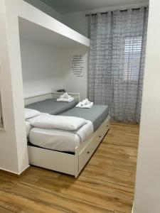 a bedroom with two beds in a room at La dimora degli scrittori in Porto Empedocle