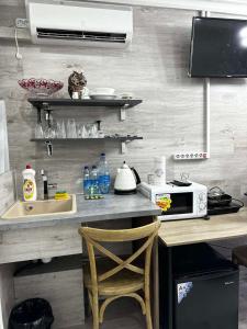 a kitchen with a counter with a sink and a microwave at Apartment in Chişinău