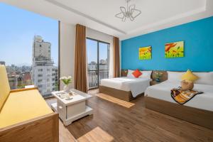 a hotel room with two beds and a large window at Beach Hotel by RAON - STAY 24H in Da Nang
