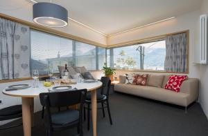 a living room with a table and a couch at Alpinetouch in Aosta