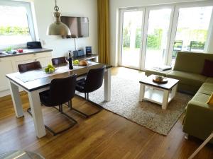 a kitchen and living room with a table and chairs at Gode Wind Quartiere 1 in Dahme