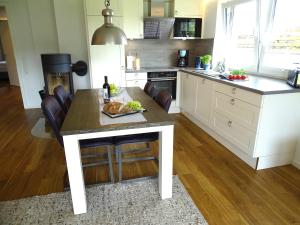 a kitchen with a table with a plate of food on it at Gode Wind Quartiere 1 in Dahme