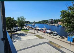 a view of a river with boats in the water at Apartament z widokiem na port in Mrzeżyno