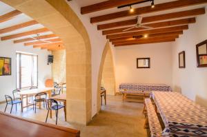 a room with tables and chairs in a building at Embat - Hostel in Montuiri