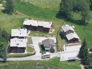 an aerial view of a large house in a field at Chalet village situated in a quiet area in Antey-Saint-André