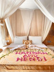 a bed with a bunch of flowers on it at Nusava Boutique Hotel in Nusa Penida