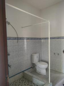 a bathroom with a toilet and a glass shower at THE TAJ Inn in Cagayan de Oro