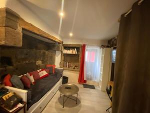 a living room with a couch and a table at Avélia Bonnevie in Murat