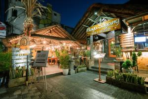a restaurant with a sign in front of it at night at Kahayana Seminyak Villa in Seminyak