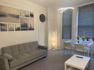 a living room with a couch and a table at Luxury,Location and Convenience in Bournemouth