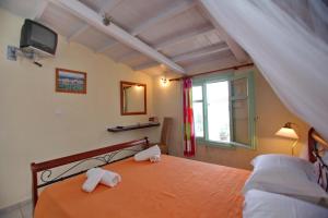 a bedroom with a bed with two towels on it at Pelagos in Stafylos
