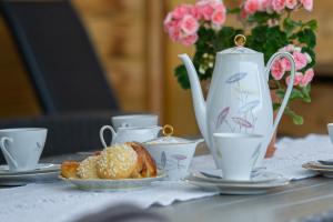 stół z dzbankiem do herbaty i talerzem jedzenia w obiekcie Vare 4 w mieście TrÃ¤slÃ¶vslÃ¤ge