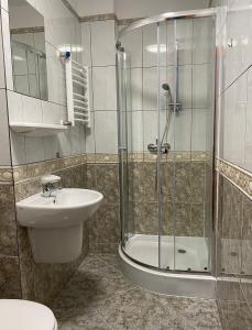 La salle de bains est pourvue d'une douche, d'un lavabo et de toilettes. dans l'établissement Zamek Nowęcin, à Łeba