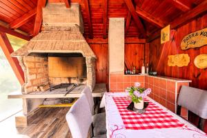 a kitchen with a table and an outdoor oven at Guesthouse Diva Grabovčeva in Perušić