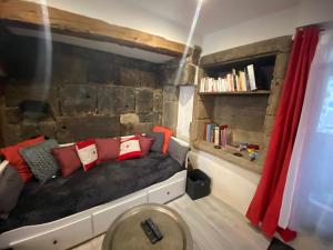 a bed with red pillows on it in a room at Avélia Bonnevie in Murat