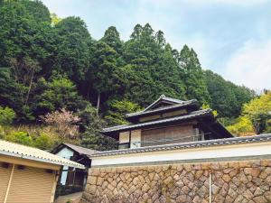 un edificio frente a una montaña con árboles en SEIYU宿, en Nara