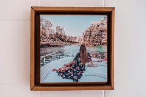 a picture of a woman sitting on a boat in the water at Acquaterra in Polignano a Mare
