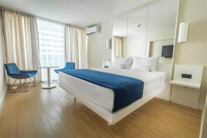 a hotel room with a bed and a table and chairs at ORBI SITY BATUMI in Batumi