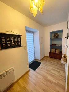 an empty living room with a window and a fan at Escale à Ploumanac'h in Perros-Guirec