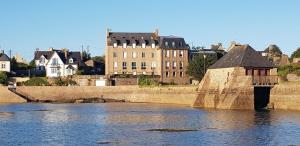 a bridge over a body of water with buildings at Escale à Ploumanac'h in Perros-Guirec
