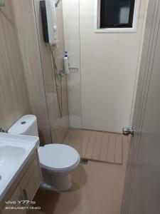 a bathroom with a white toilet and a shower at youth city residence in Nilai