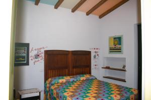 a bedroom with a bed with a wooden headboard at Casa Nupa in Torri in Sabina