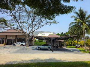 a car parked in a parking lot in front of a building at Baan Mesuk Hua Hin Spa and Resort in Hua Hin