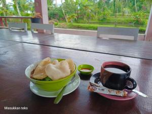 a bowl of bread and a cup of coffee on a table at Talaga Tomohon Home Stay and Fishing Pond in Tomohon +41 photos