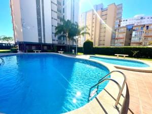 a large swimming pool in a city with buildings at Casa Lua un espacio ideal para familias in Playa de Gandia